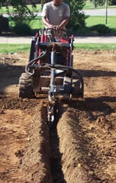 Paul is using a trencher to install a new sprinkler system